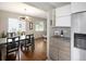 Bright dining area with hardwood floors, modern lighting, and a view of the kitchen at 1852 S Elm St, Denver, CO 80222