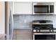 Bright kitchen showcasing stainless steel appliances, modern cabinets and grey tile backsplash at 1852 S Elm St, Denver, CO 80222