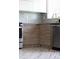 Well-lit kitchen featuring modern wood cabinets, stainless steel appliances and grey tile backsplash at 1852 S Elm St, Denver, CO 80222