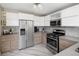 Kitchen featuring stainless steel appliances, modern cabinetry, and stylish backsplash at 1852 S Elm St, Denver, CO 80222