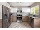 Contemporary kitchen featuring stainless steel appliances, modern cabinetry, and stylish backsplash at 1852 S Elm St, Denver, CO 80222