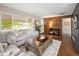 Bright living room featuring hardwood floors, a modern sofa, and a decorative wood accent wall at 1852 S Elm St, Denver, CO 80222