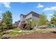 Well-manicured backyard with a deck, lush lawn, landscaping, and a rock garden feature at 1114 Basalt Ridge Loop, Castle Rock, CO 80108