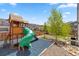 Backyard featuring a wooden play structure, landscaping, and stone accents, creating a fun outdoor space at 1114 Basalt Ridge Loop, Castle Rock, CO 80108