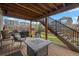 Cozy backyard patio with fire pit, seating, and easy access stairs to yard at 1114 Basalt Ridge Loop, Castle Rock, CO 80108