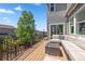 Inviting outdoor deck with comfortable lounge seating and scenic neighborhood views on a sunny day at 1114 Basalt Ridge Loop, Castle Rock, CO 80108