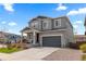 Two-story home showcasing gray siding, a two-car garage, and a charming covered front porch at 1114 Basalt Ridge Loop, Castle Rock, CO 80108