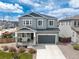 Two-story home featuring gray siding, a two-car garage, a covered porch, and a well-maintained front yard at 1114 Basalt Ridge Loop, Castle Rock, CO 80108