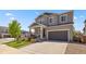 Attractive two-story house with a well-kept lawn and an attached two-car garage on a sunny day at 1114 Basalt Ridge Loop, Castle Rock, CO 80108