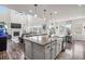 Open-concept kitchen with a large island, granite countertops, and modern appliances flowing into the living room at 1114 Basalt Ridge Loop, Castle Rock, CO 80108