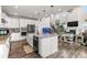 Kitchen with white cabinetry, stainless appliances, granite countertops, large island, and eat-in breakfast bar at 1114 Basalt Ridge Loop, Castle Rock, CO 80108