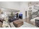 Open-concept living room showcasing the kitchen, stairs, high ceilings, modern furniture, and hardwood floors at 1114 Basalt Ridge Loop, Castle Rock, CO 80108
