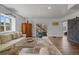 Inviting living room with a cozy sectional sofa, wood floors, and access to outdoor space at 1114 Basalt Ridge Loop, Castle Rock, CO 80108