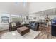 Bright, open living room featuring high ceilings and seamless flow into a modern kitchen with granite countertops at 1114 Basalt Ridge Loop, Castle Rock, CO 80108