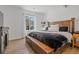 Serene primary bedroom with a large bed, hardwood floors, and plenty of natural light at 1114 Basalt Ridge Loop, Castle Rock, CO 80108