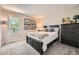 Cozy bedroom with a large window, black bed frame, and neutral decor at 17509 E Kenyon Dr, Aurora, CO 80013
