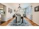 Stylish dining room features modern lighting, hardwood floors, and patterned curtains for an elegant touch at 17509 E Kenyon Dr, Aurora, CO 80013