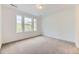 Bright bedroom featuring large windows, neutral carpet flooring, and neutral paint throughout at 7440 S Yank Ct, Littleton, CO 80127