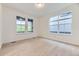 Bright bedroom features light wood floors, white walls, and three large windows offering plenty of natural light at 7440 S Yank Ct, Littleton, CO 80127
