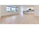 Bright living room featuring large windows, light hardwood floors, and neutral paint throughout at 7440 S Yank Ct, Littleton, CO 80127