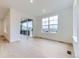 Bright living room featuring large windows, sliding glass door and hardwood floors, and neutral paint throughout at 7440 S Yank Ct, Littleton, CO 80127