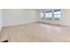 Bright living room featuring large windows, light hardwood floors, and neutral paint throughout at 7440 S Yank Ct, Littleton, CO 80127