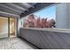 View from covered balcony with wood flooring, showing seasonal foliage at 9837 E Peakview Ave # D05, Englewood, CO 80111