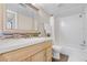 Clean, well-lit bathroom featuring a vanity with a large mirror and a shower-tub combo at 9837 E Peakview Ave # D05, Englewood, CO 80111
