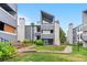 Daytime view of a stylish condo exterior with well-manicured lawn and inviting entrance at 9837 E Peakview Ave # D05, Englewood, CO 80111