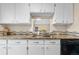 This kitchen features matching white cabinets and a dark granite countertop at 9837 E Peakview Ave # D05, Englewood, CO 80111