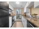 The kitchen is bright and features black appliances and laminate countertops at 9837 E Peakview Ave # D05, Englewood, CO 80111