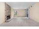 Bright living space with a stone fireplace, carpet, and sliding doors to the outside at 9837 E Peakview Ave # D05, Englewood, CO 80111