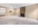 Spacious living area with a stone fireplace, carpet, and a cozy atmosphere at 9837 E Peakview Ave # D05, Englewood, CO 80111