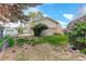 A well-maintained backyard is shown, featuring ample space with mature trees and landscaping at 11241 Ogden Dr, Northglenn, CO 80233
