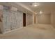 A finished basement featuring painted brick and carpet creates a warm and inviting space at 11241 Ogden Dr, Northglenn, CO 80233