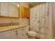 The inviting bathroom offers a granite vanity and shower with stylish curtain at 11241 Ogden Dr, Northglenn, CO 80233