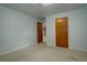 Neutral bedroom with neutral carpet and a wooden door at 11241 Ogden Dr, Northglenn, CO 80233