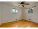 Sunlit bedroom with gleaming hardwood floors and a ceiling fan provides a comfortable retreat at 11241 Ogden Dr, Northglenn, CO 80233