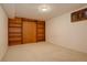 Bedroom featuring carpet and built-in shelves, offering storage solutions at 11241 Ogden Dr, Northglenn, CO 80233