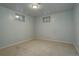 Bright bedroom with neutral carpet and natural light from two windows at 11241 Ogden Dr, Northglenn, CO 80233