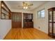 Cozy dining area with hardwood floors, built-in shelving, an elegant hutch, and a charming ceiling fan at 11241 Ogden Dr, Northglenn, CO 80233