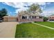 Inviting exterior showcasing a manicured lawn and a walkway leading to the charming single-story home at 11241 Ogden Dr, Northglenn, CO 80233