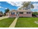 Charming single-story home with brick accents, well-maintained lawn, and inviting walkway to the front door at 11241 Ogden Dr, Northglenn, CO 80233