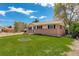 Inviting home with a manicured front lawn and brick and siding exterior at 11241 Ogden Dr, Northglenn, CO 80233