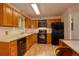Functional kitchen equipped with wood cabinetry, modern appliances, and ample counter space for meal preparation at 11241 Ogden Dr, Northglenn, CO 80233