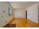 Bright living area featuring hardwood floors and a large window that illuminates the interior space at 11241 Ogden Dr, Northglenn, CO 80233