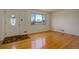 Bright living room features hardwood floors, a large window, and a welcoming front door with a decorative glass design at 11241 Ogden Dr, Northglenn, CO 80233