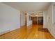 Open living space with hardwood floors, a view into the dining area, and abundant natural light at 11241 Ogden Dr, Northglenn, CO 80233