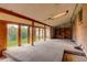 Sunroom with wood beams, carpet, and view of backyard at 11241 Ogden Dr, Northglenn, CO 80233