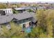 Stunning aerial view of a home with a gray roof, a backyard pool, and lush trees at 2821 E Cedar Ave # 2, Denver, CO 80209